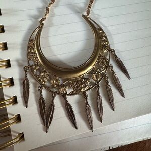 Gold tone Crescent Necklace with cherub, roses, feathers